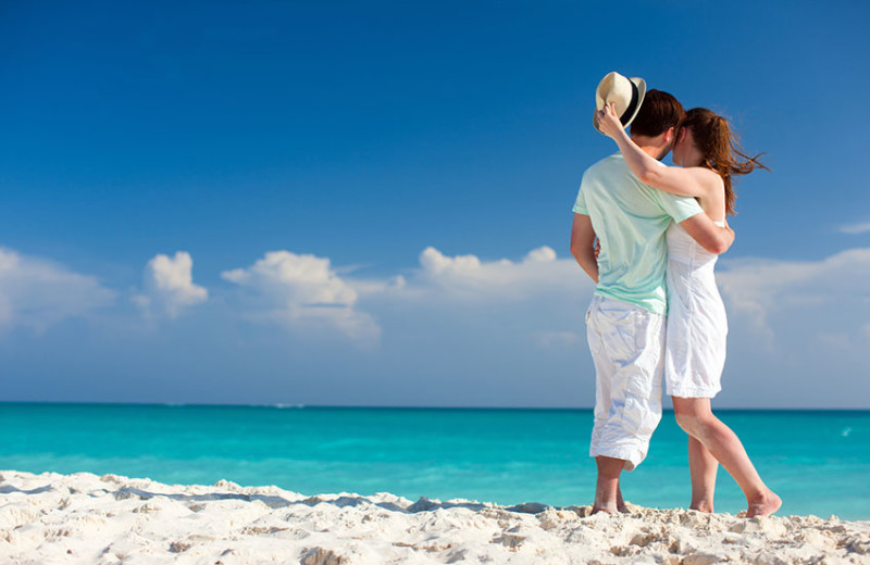 Couple on beach at Bric Vacation Rentals.