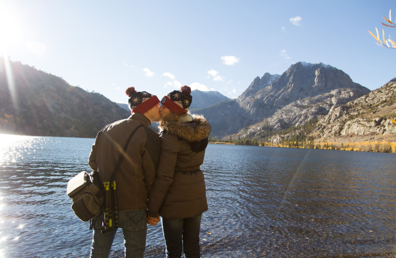 Couple by lake at Nomadness Rentals.