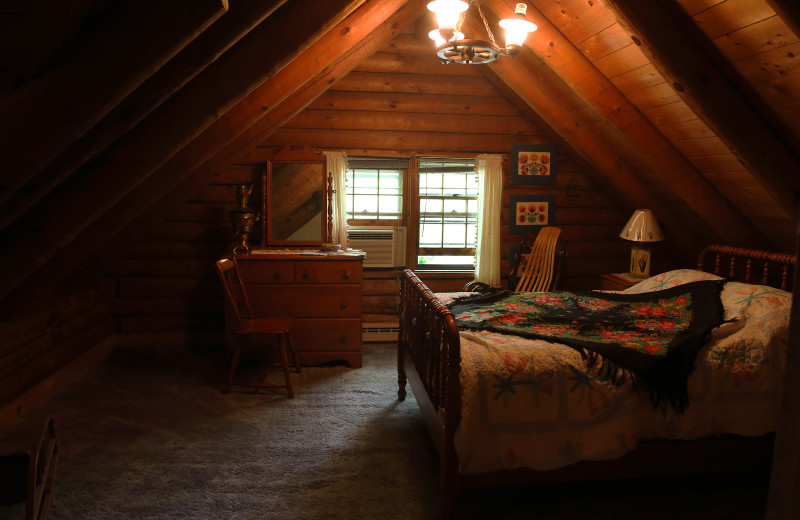 Guest room at Log Country Inn Bed 