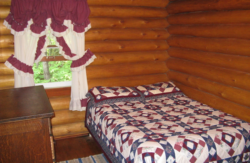 Cabin bedroom at Herseth's Tomahawk Resort.