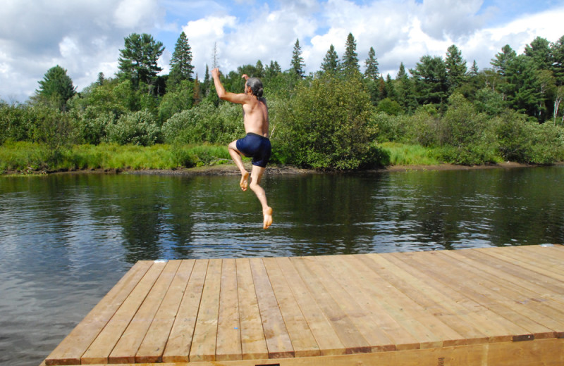 Jumping in lake at Wolf Den Hostel and Nature Retreat.