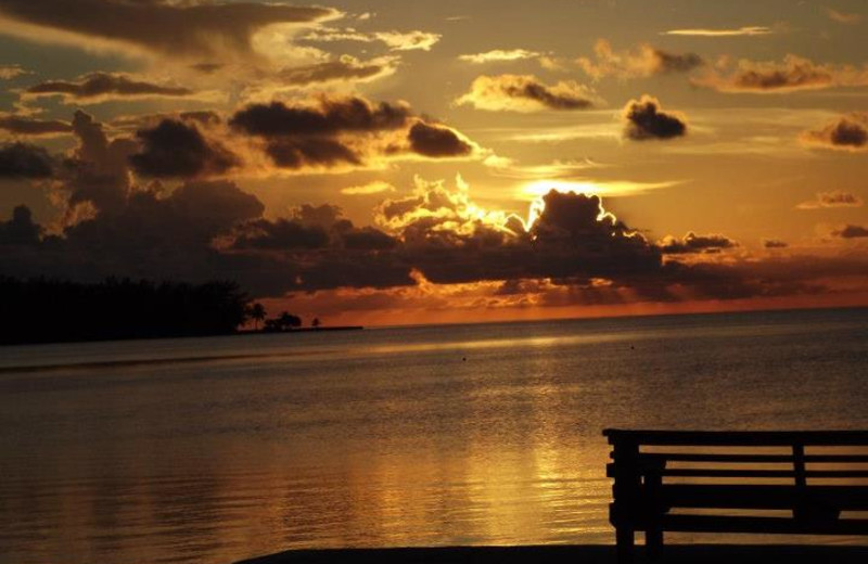Sunset over ocean at Coral Bay Resort.