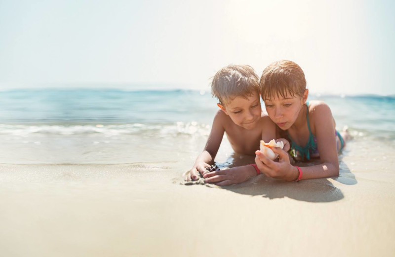 Family on beach at Palm Island Resort.