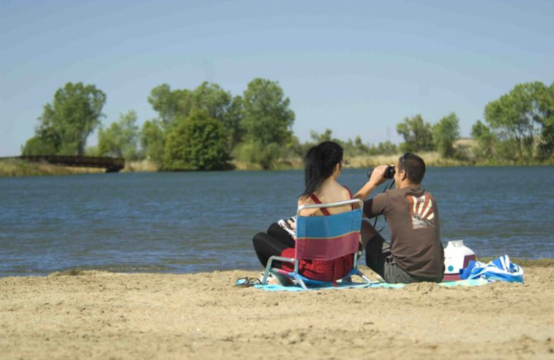 Couple sitting on shore at Lake Oroville.