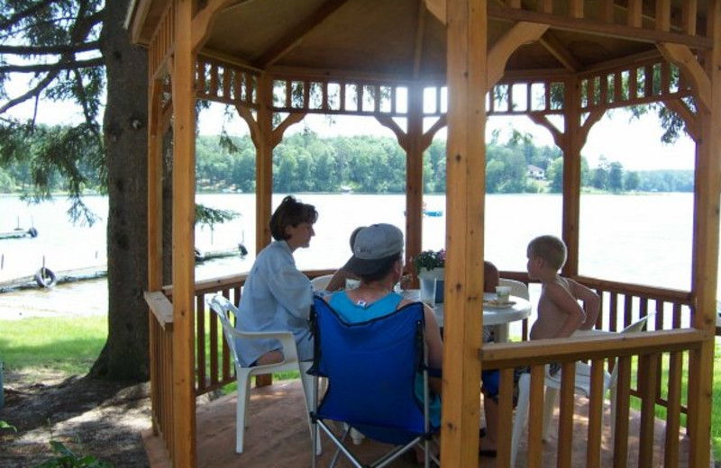 Family in the gazebo by the lake at Shady Hollow Resort.