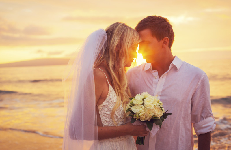 Couple on beach at Meredith Lodging LLC.