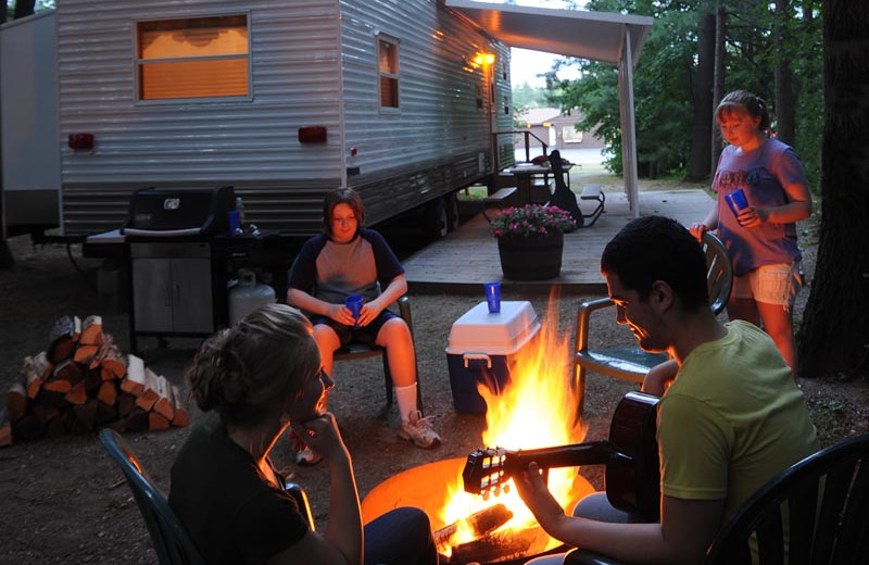 Family by the campfire at Lake George RV Park.