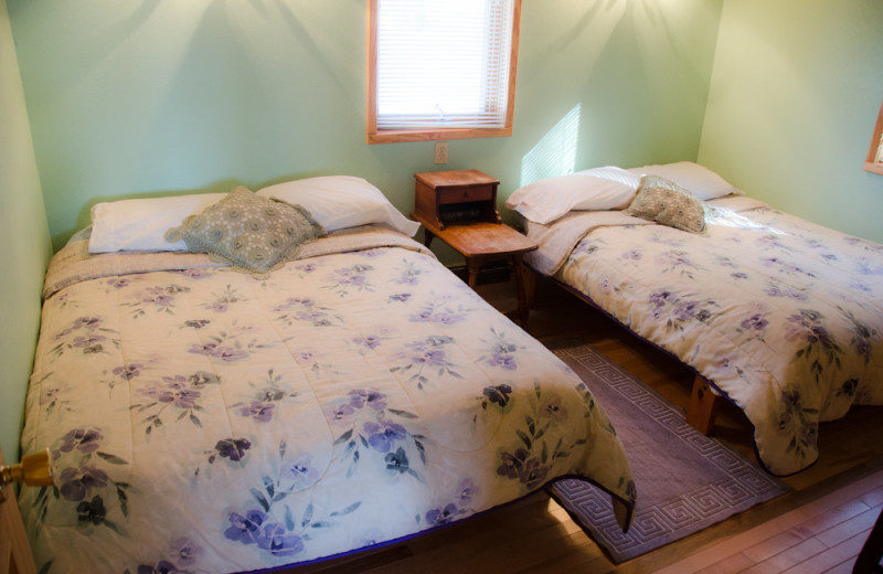 Cabin bedroom at Tri Lake Timbers Resort.