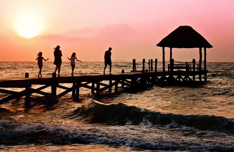 Family on beach at Vacation Pool Homes.