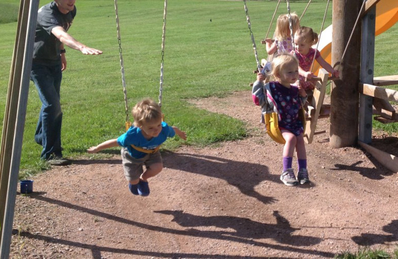 Kids on swings at High Country Guest Ranch.