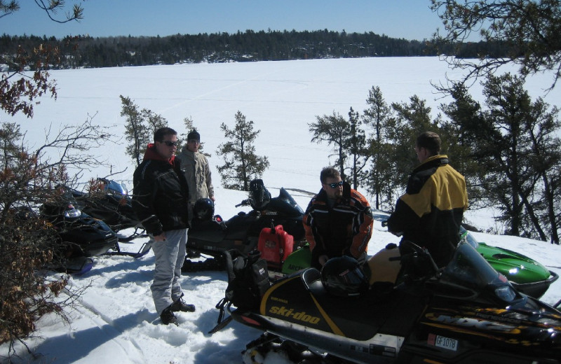 Snowmobiling along the trail at Ash-Ka-Nam.