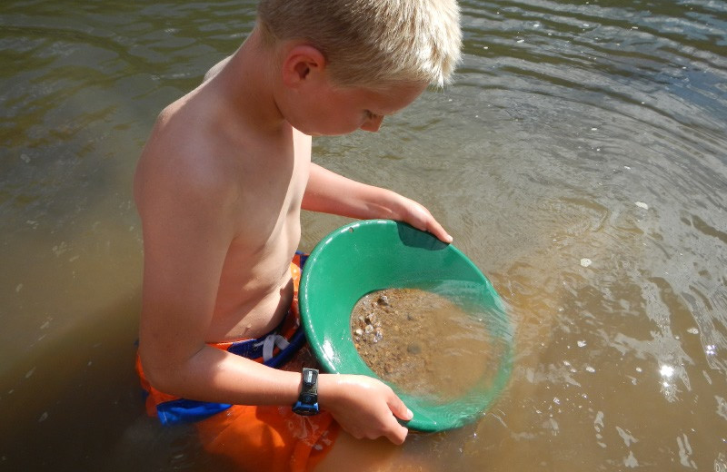 Kid panning for gold at China Bar Lodge.