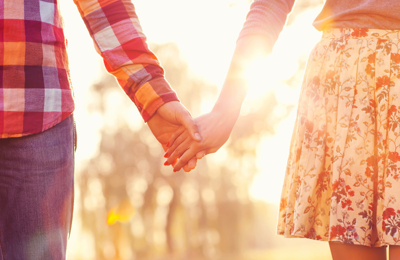 Couple holding hands at Acorn Lodge.