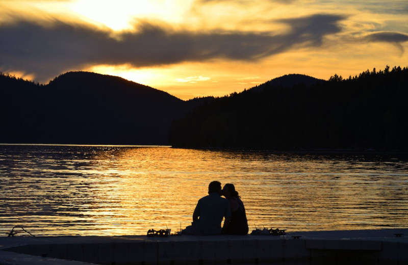 Couple by lake at The Lodge at Whitefish Lake.