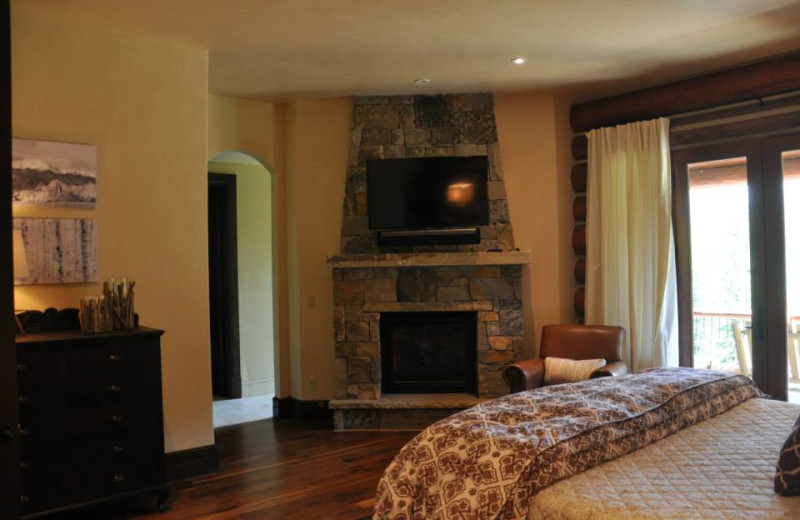 Vacation rental bedroom with fireplace at SilverStar Luxury Properties.