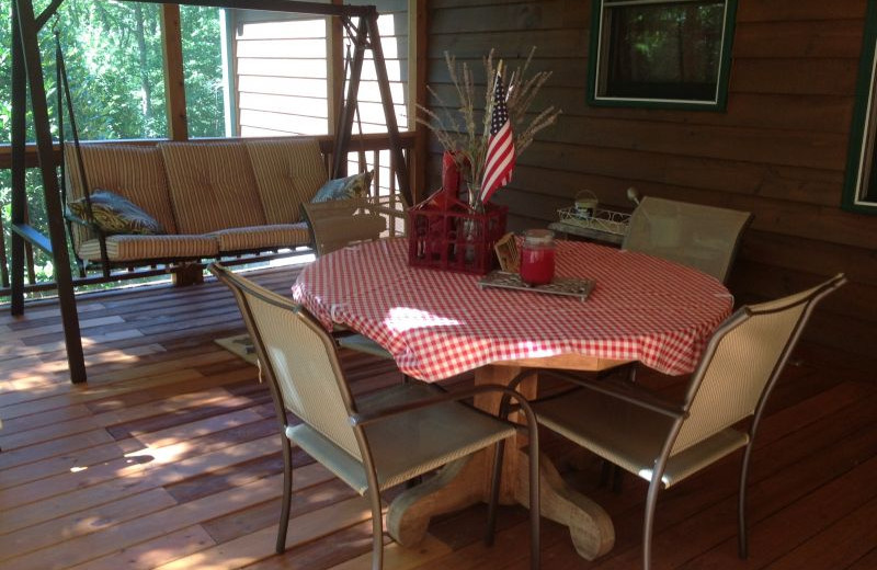 Cabin deck with swinging bench at Avenair Mountain Cabins.