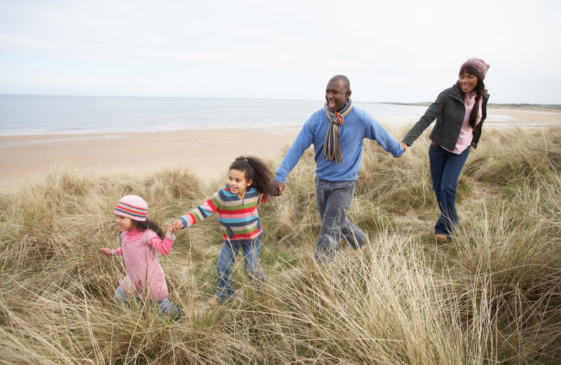 Family on beach at East Islands Rentals.