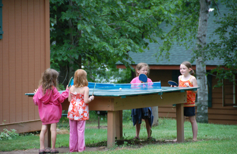 Family playing ping pong at Woodland Beach Resort.