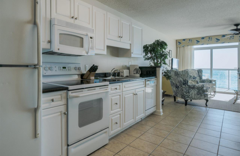 Rental kitchen at CondoLux Vacation Rentals.