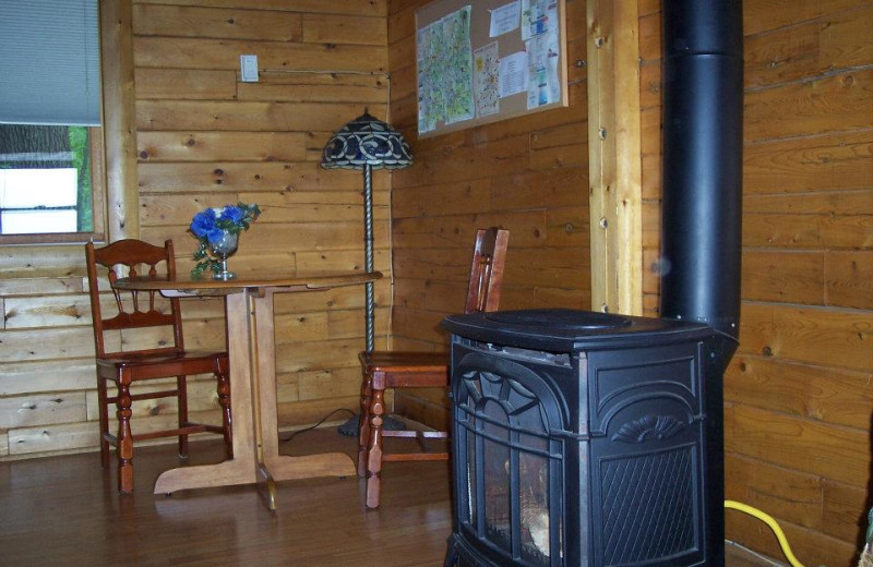 Cabin fireplace and dining table at Sunset Ridge Log Cabins.