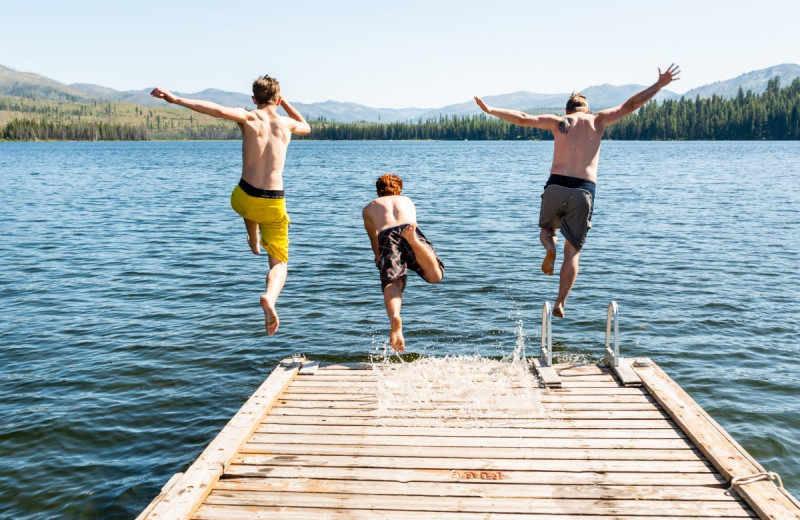 Kids jumping off dock at North Shore Lodge & Resort.