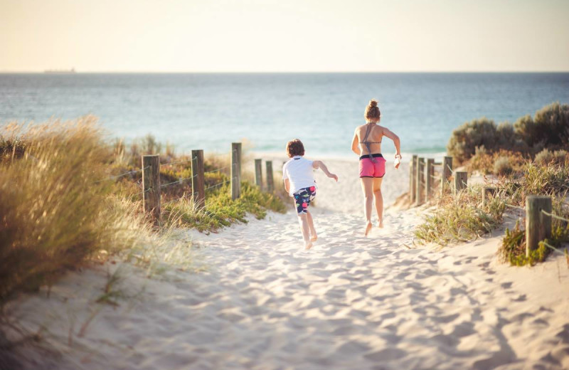 Kids running to beach at Boardwalk Plaza Hotel.