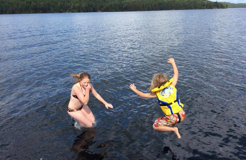 Kids jumping in lake at Dunlop Lake Lodge.