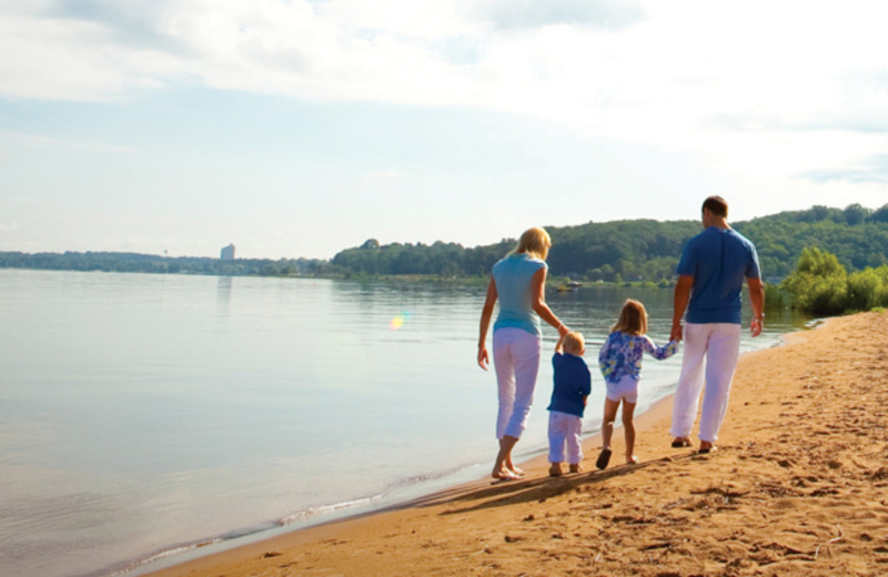 Family walking on beach at Tamarack Lodge.