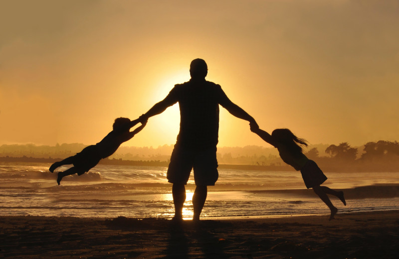 Family on beach at Northumberland Heights Wellness Retreat and Spa.