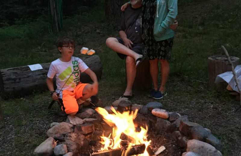 Family roasting marshmallows at Bear Paw Lodge.