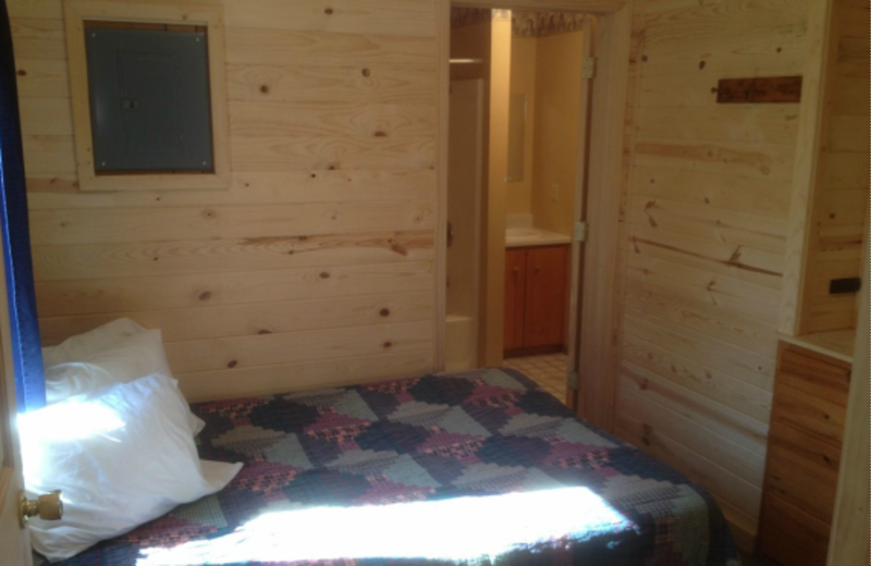 Cabin bedroom at Whispering Pines Resort.