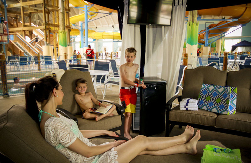 Family lounging in a private indoor cabana in Breaker Bay Waterpark at Blue Harbor Resort.