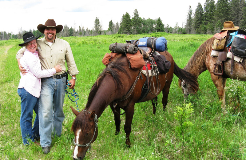 Couple with horses at Trailhead Ranch.