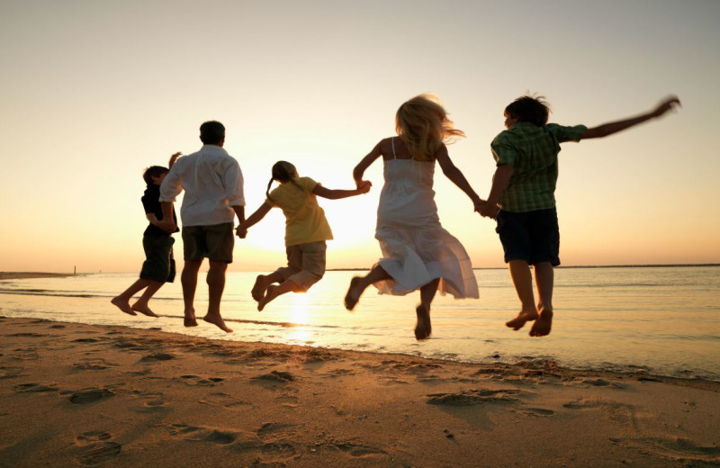 Family on beach at Rivertide Suites Hotel.