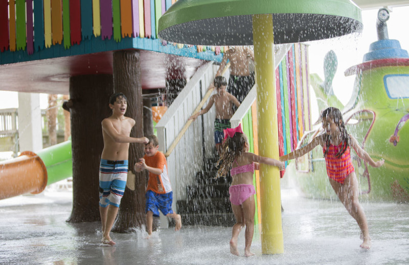 Kids playing in splash pad at Crown Reef Resort.