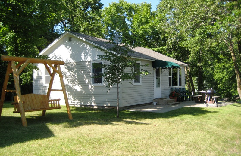 Cabin exterior with swinging bench at East Silent Resort.