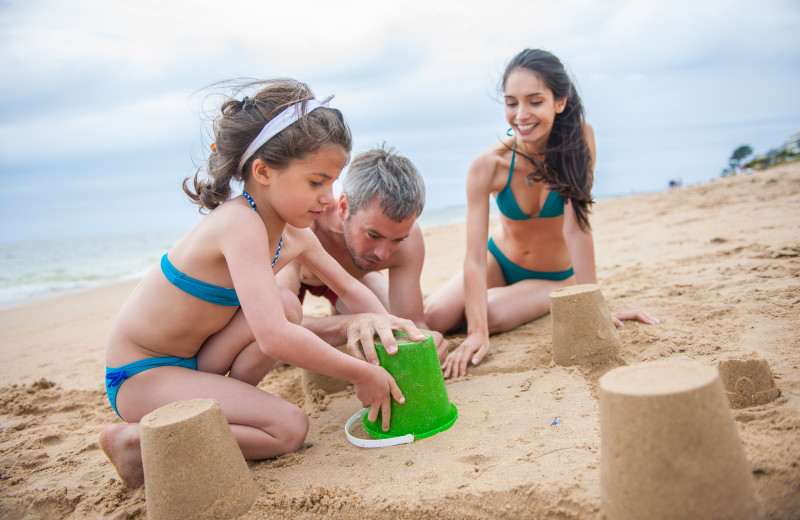 Family on beach at Caprice Resort.