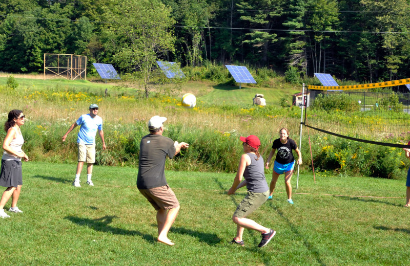 Families enjoy a pick-up game of volleyball at Common Ground Center.