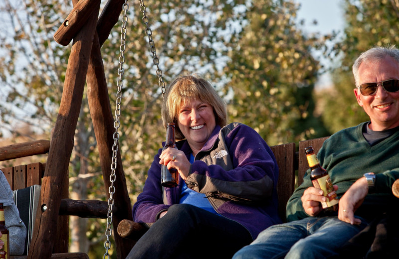 Couple on swing bench at Goosewing Ranch.