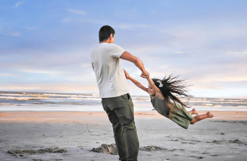 Family on beach at Starkey Properties.