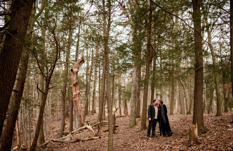 Couple in forest at Arrow Park Lake and Lodge.