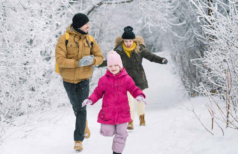 Winter family running through snow at Wilsons on Moosehead Lake.