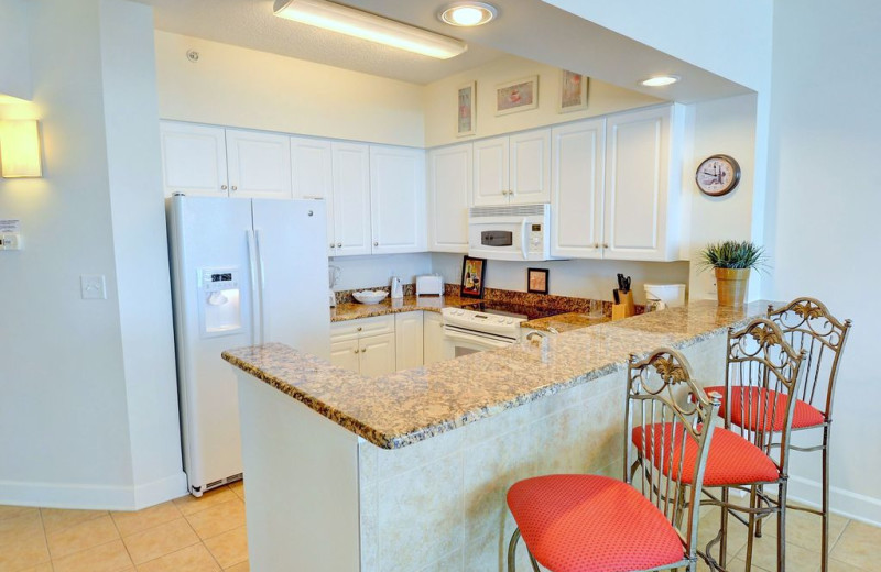Rental kitchen at CondoLux Vacation Rentals.