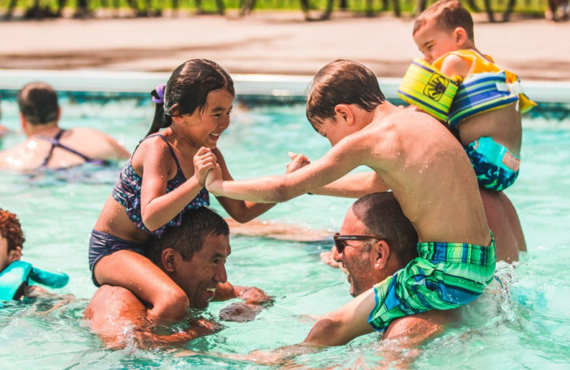 Family in pool at Great Blue Resorts- Bellmere Winds Resort.