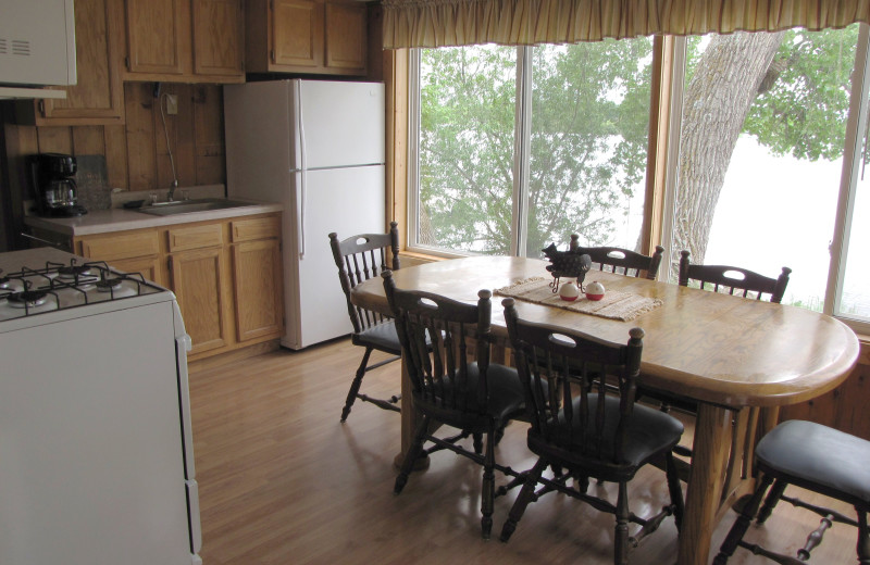 Cabin kitchen and dining table at Mill Lake Resort.