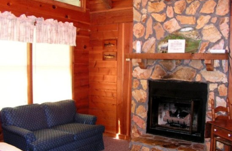 Cabin fireplace living room at Timberloft Cabin Rentals.