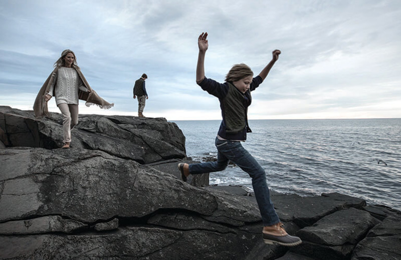 Family on rocks at Cliff House Maine.