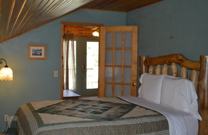 Cabin bedroom at Mulberry Mountain Lodging & Events.