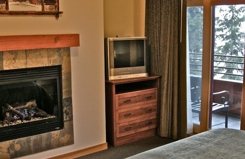 Guest bedroom with fireplace at The Lodge at Sandpoint.