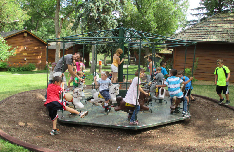 Kids on merry-go-round at  Sylvan Dale Guest Ranch.